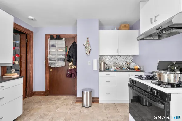 a kitchen with stainless steel appliances granite countertop a stove and a refrigerator