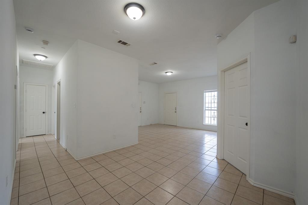 1302 Hendricks Avenue Dallas, TX 75216 - Photo 4 of 12 an empty room with white walls and tiles