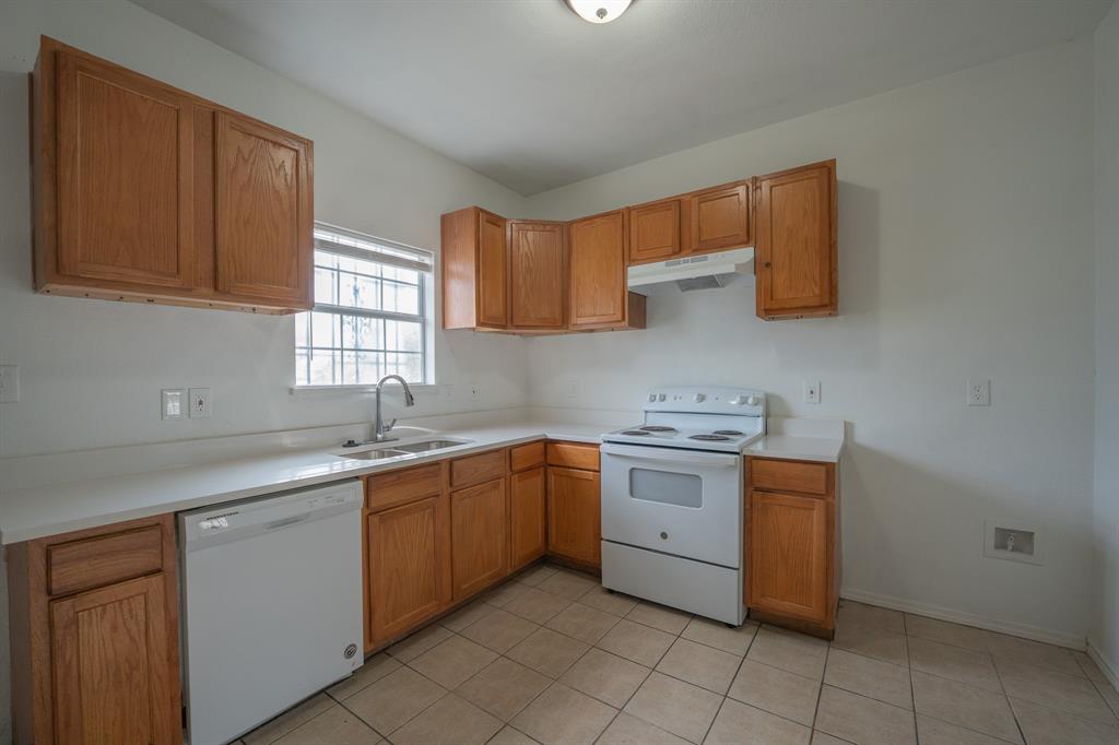1302 Hendricks Avenue Dallas, TX 75216 - Photo 5 of 12 a kitchen with a sink stove and cabinets