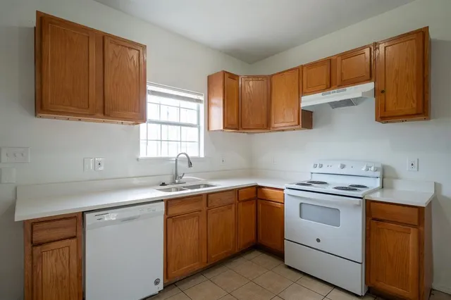 a kitchen with a sink stove and cabinets