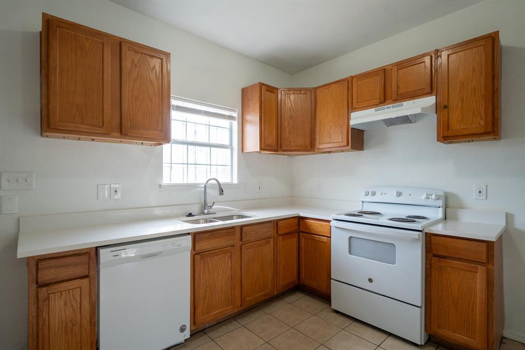 1302 Hendricks Avenue Dallas, TX 75216 - Photo 6 of 12 a kitchen with a sink stove and cabinets