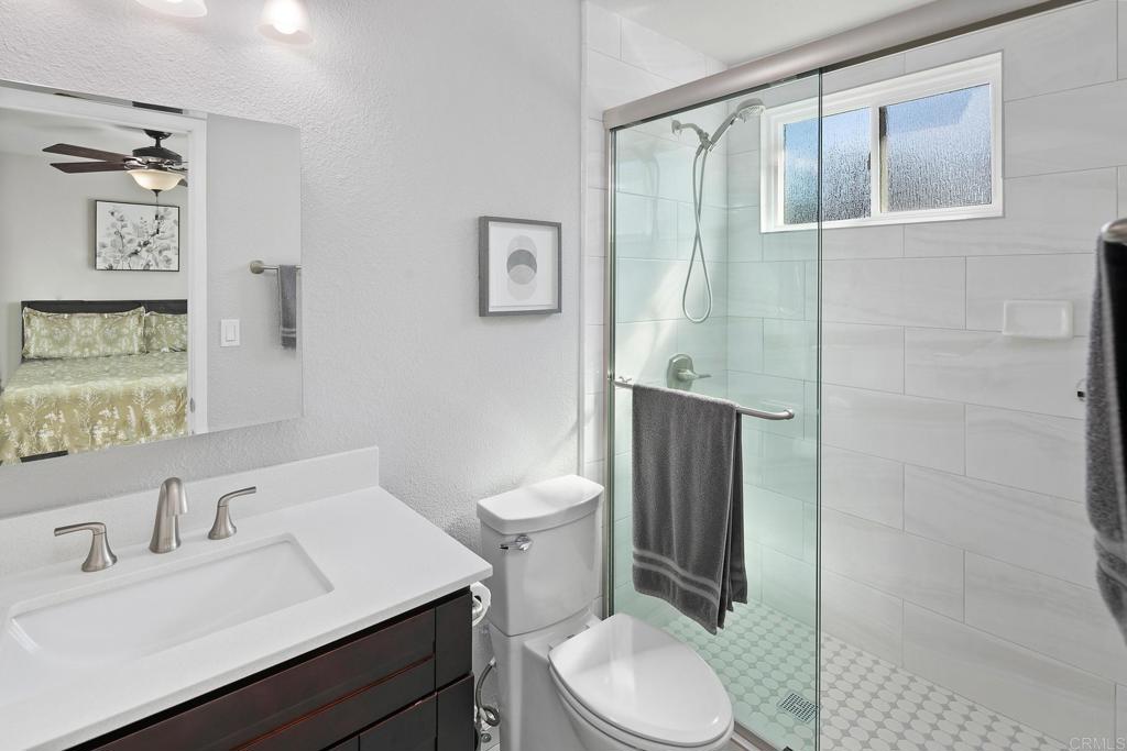 10033 Woodpark Drive Santee, CA 92071 - Photo 15 of 21 a bathroom with a sink a toilet and shower