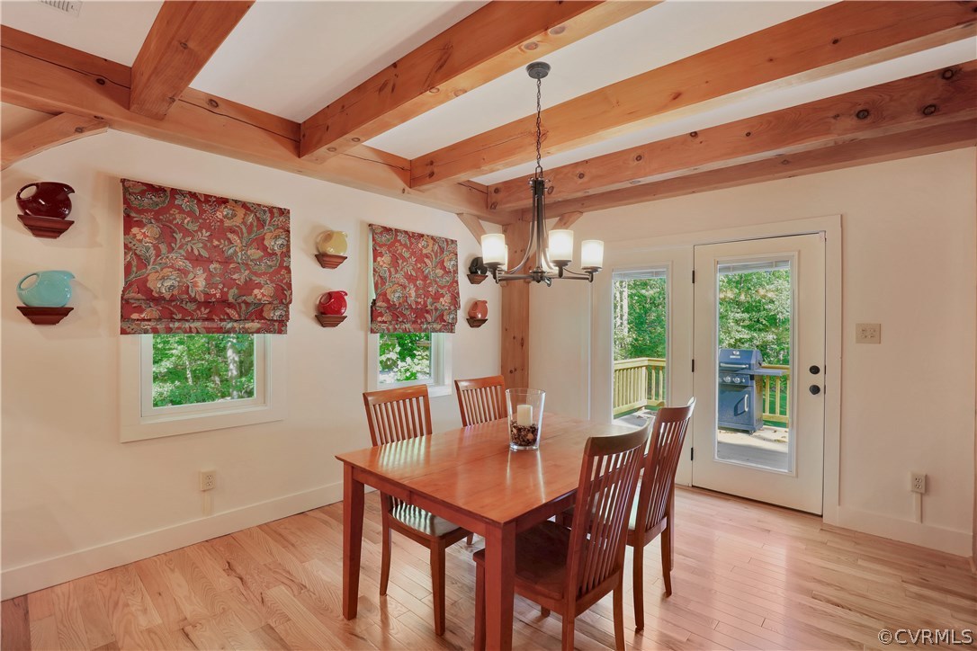 3650 Whitehall Road Sandy Hook, VA 23153 - Photo 12 of 45 a view of a dining room with furniture a potted plant and wooden floor