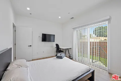 a bedroom with a bed and a tv