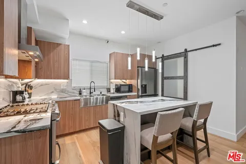 a kitchen with a stove a refrigerator and a dining table