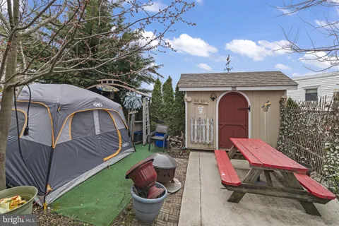 a view of backyard with deck and outdoor seating