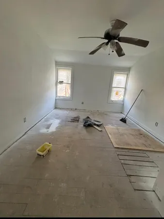 a view of a room with a ceiling fan