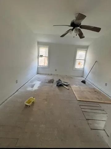 a view of a room with a ceiling fan