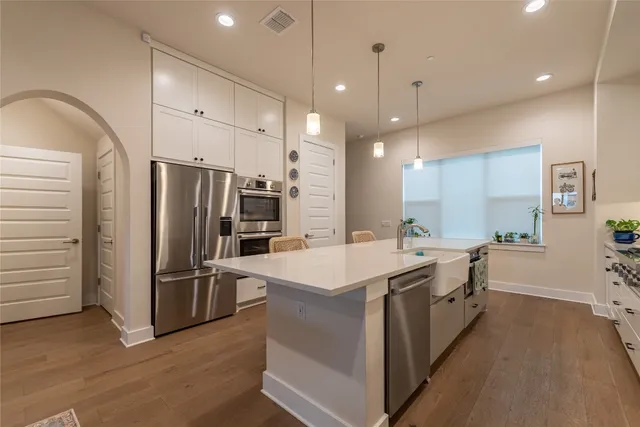 a kitchen with a sink appliances and cabinets