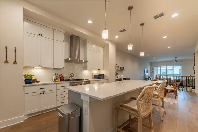 a view of a hallway with wooden floor and a potted plant