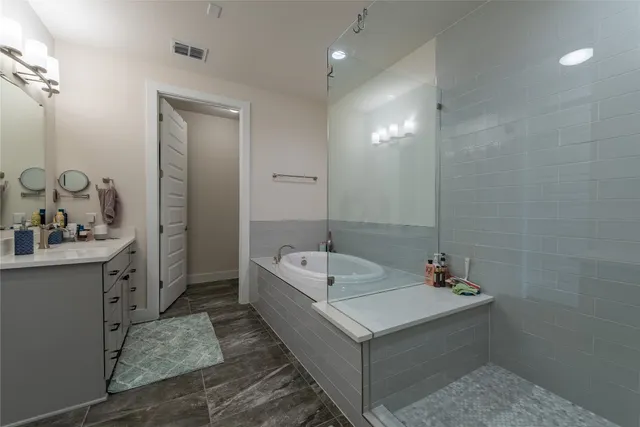 a large bed sitting in a bedroom next to a window