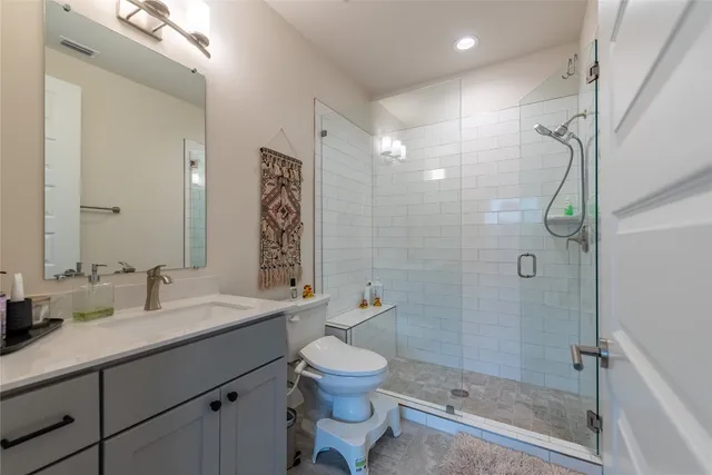 a bathroom with a glass door shower