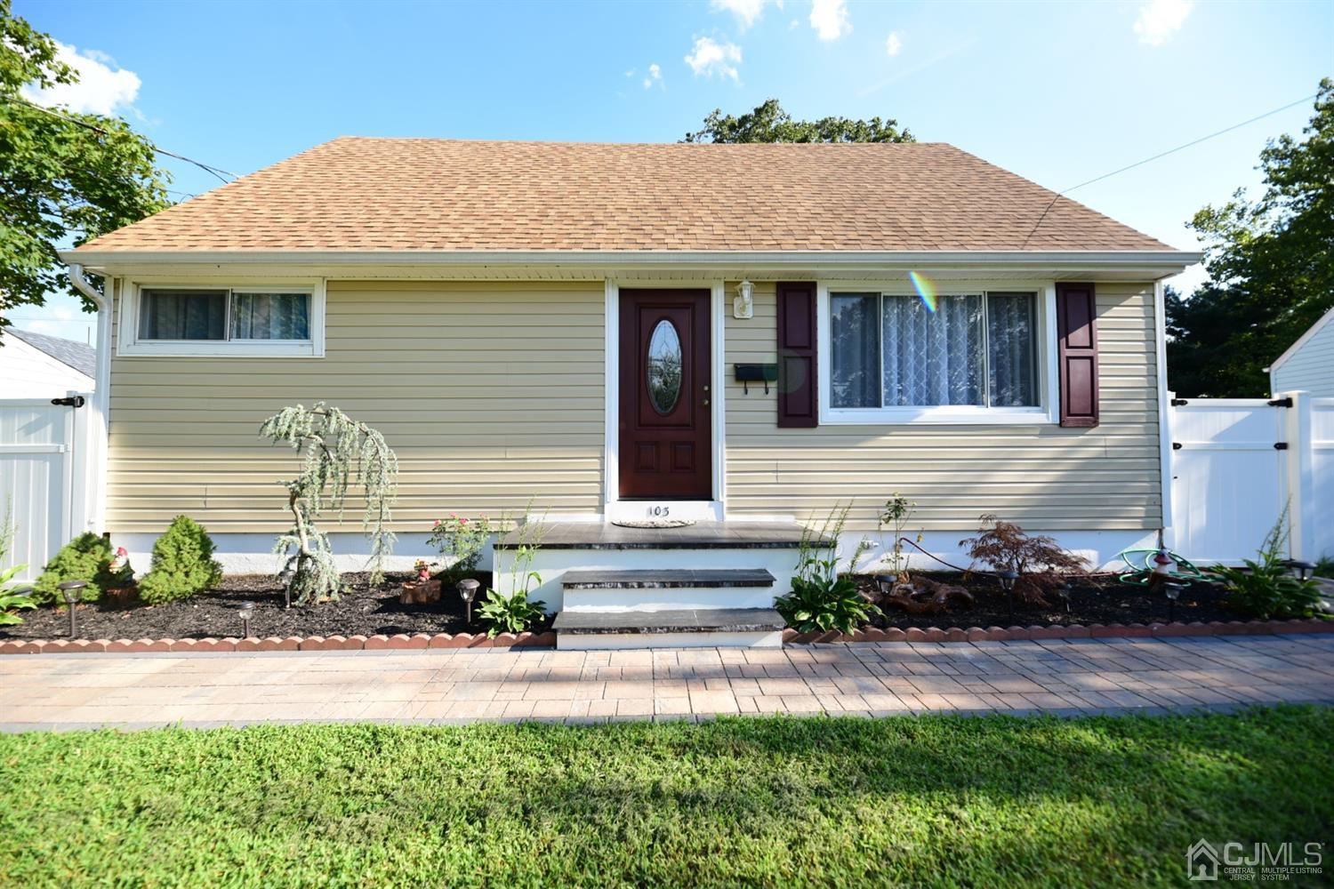 103 Tunison Road New Brunswick, NJ 08901 - Photo 1 of 30 a front view of a house with a yard and potted plants