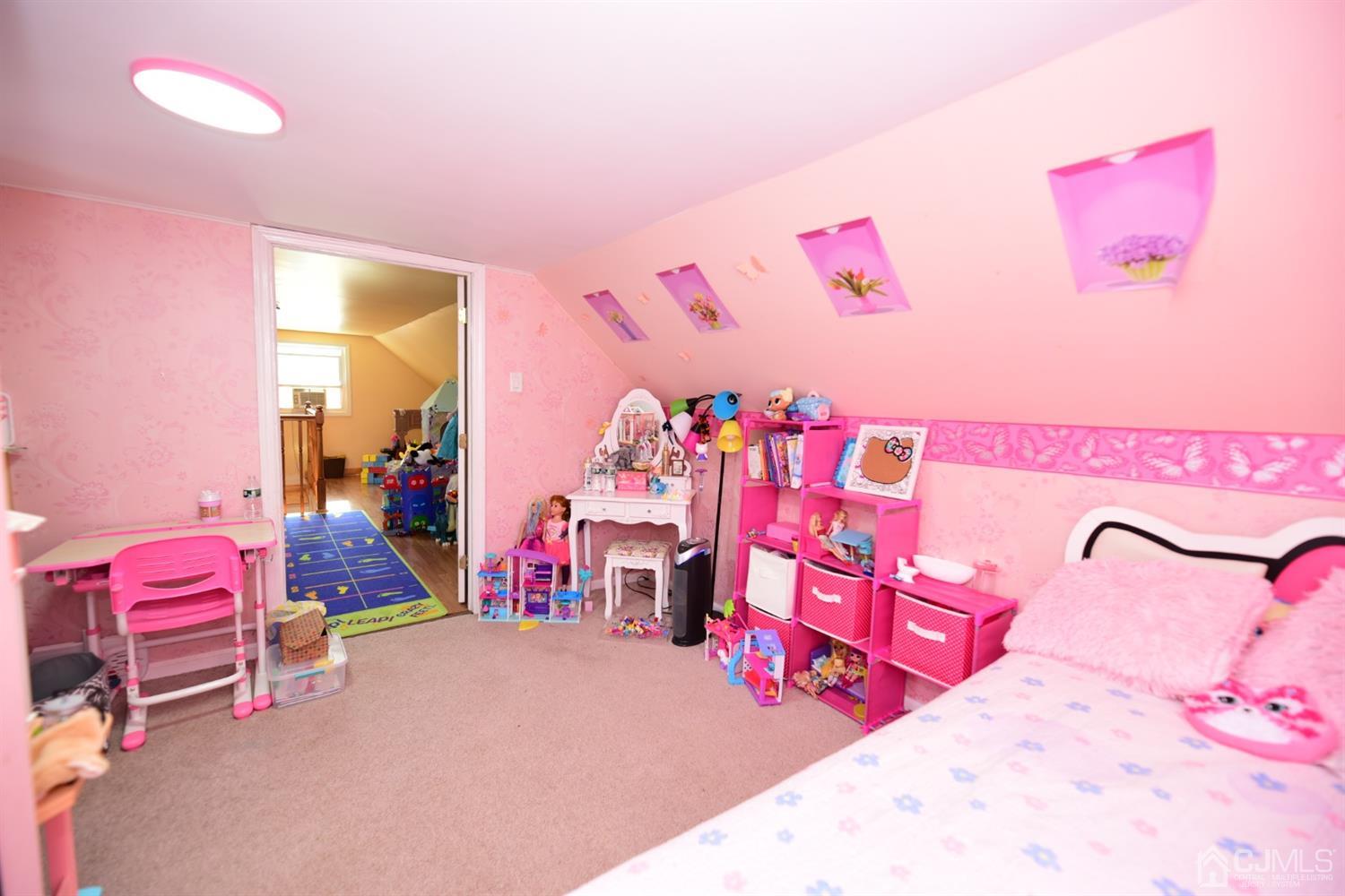 103 Tunison Road New Brunswick, NJ 08901 - Photo 17 of 30 a bedroom with pink walls and pink couch