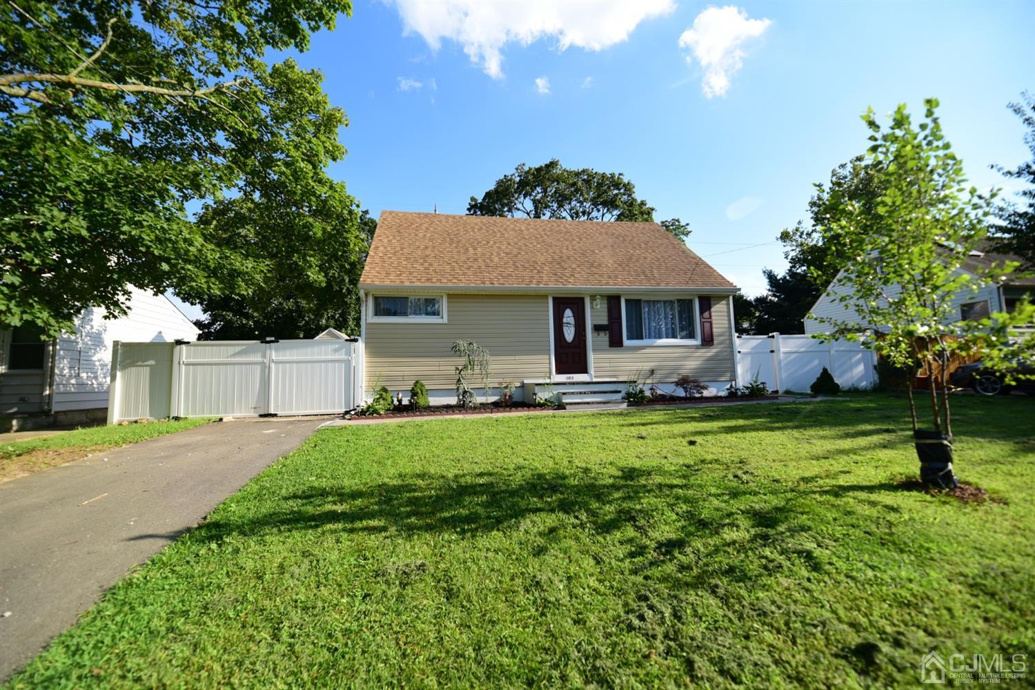 103 Tunison Road New Brunswick, NJ 08901 - Photo 3 of 30 a front view of a house with a yard and trees
