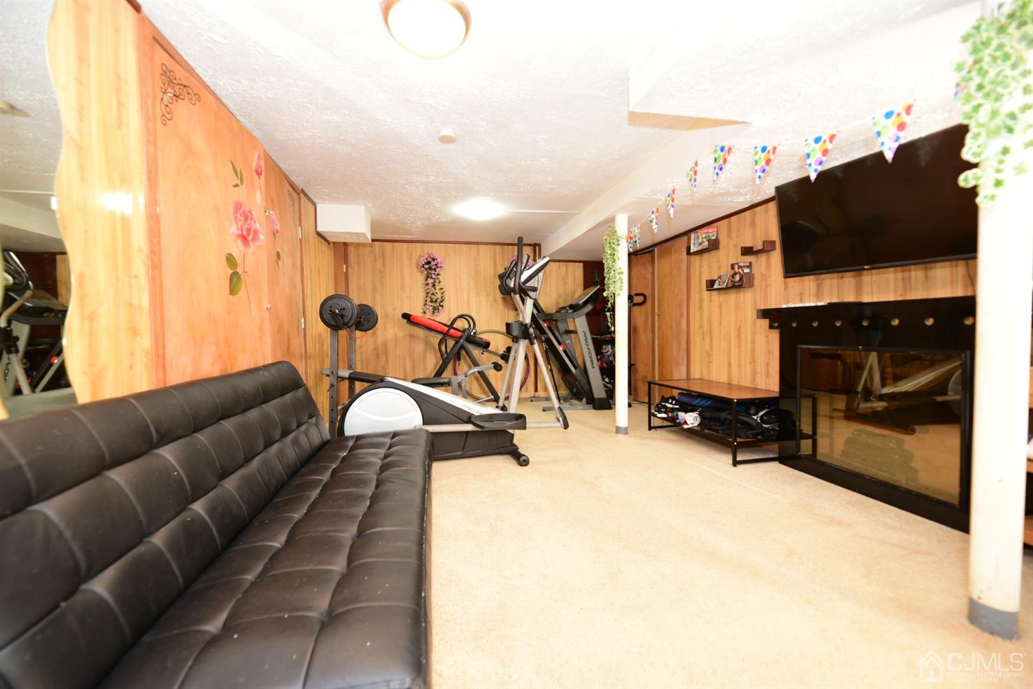 103 Tunison Road New Brunswick, NJ 08901 - Photo 22 of 30 a view of a living room with furniture and a flat screen tv