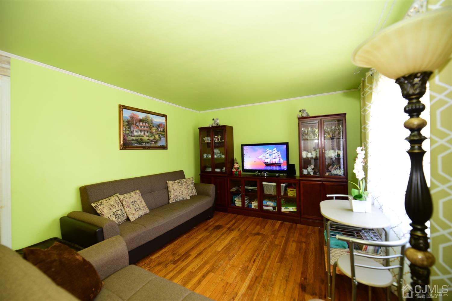 103 Tunison Road New Brunswick, NJ 08901 - Photo 4 of 30 a living room with furniture and a flat screen tv