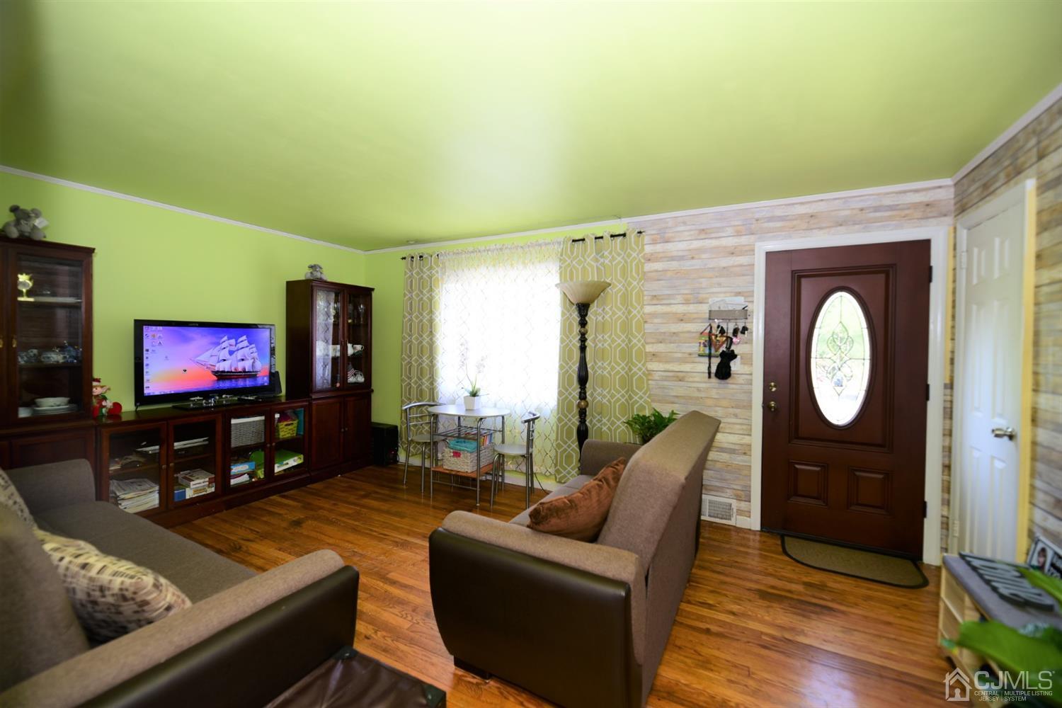 103 Tunison Road New Brunswick, NJ 08901 - Photo 5 of 30 a living room with furniture and a flat screen tv