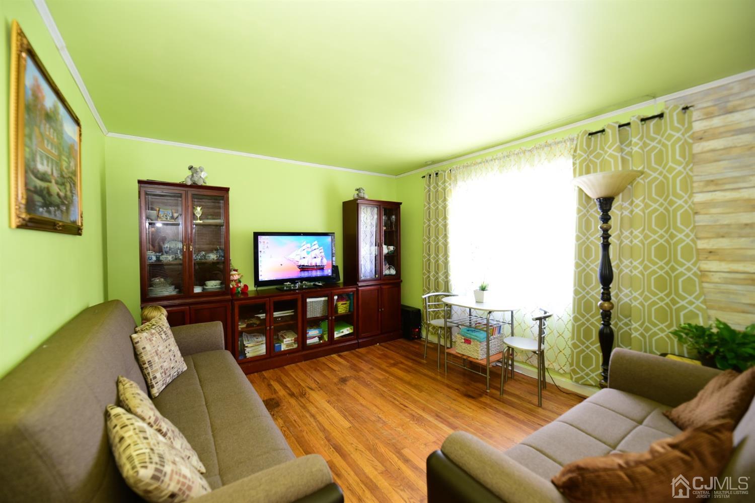 103 Tunison Road New Brunswick, NJ 08901 - Photo 6 of 30 a living room with furniture and a flat screen tv