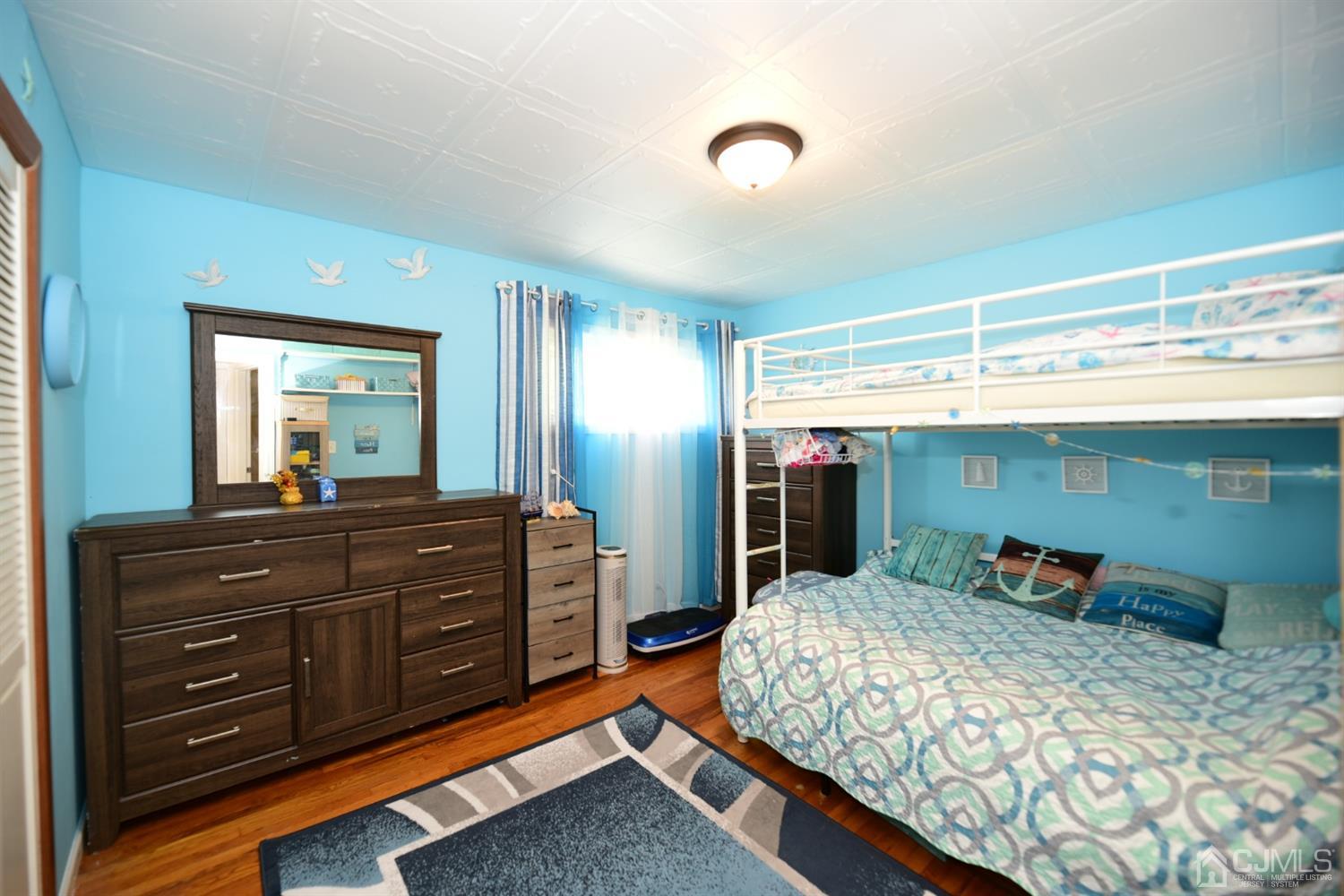 103 Tunison Road New Brunswick, NJ 08901 - Photo 8 of 30 a bed room with a bed and a dresser
