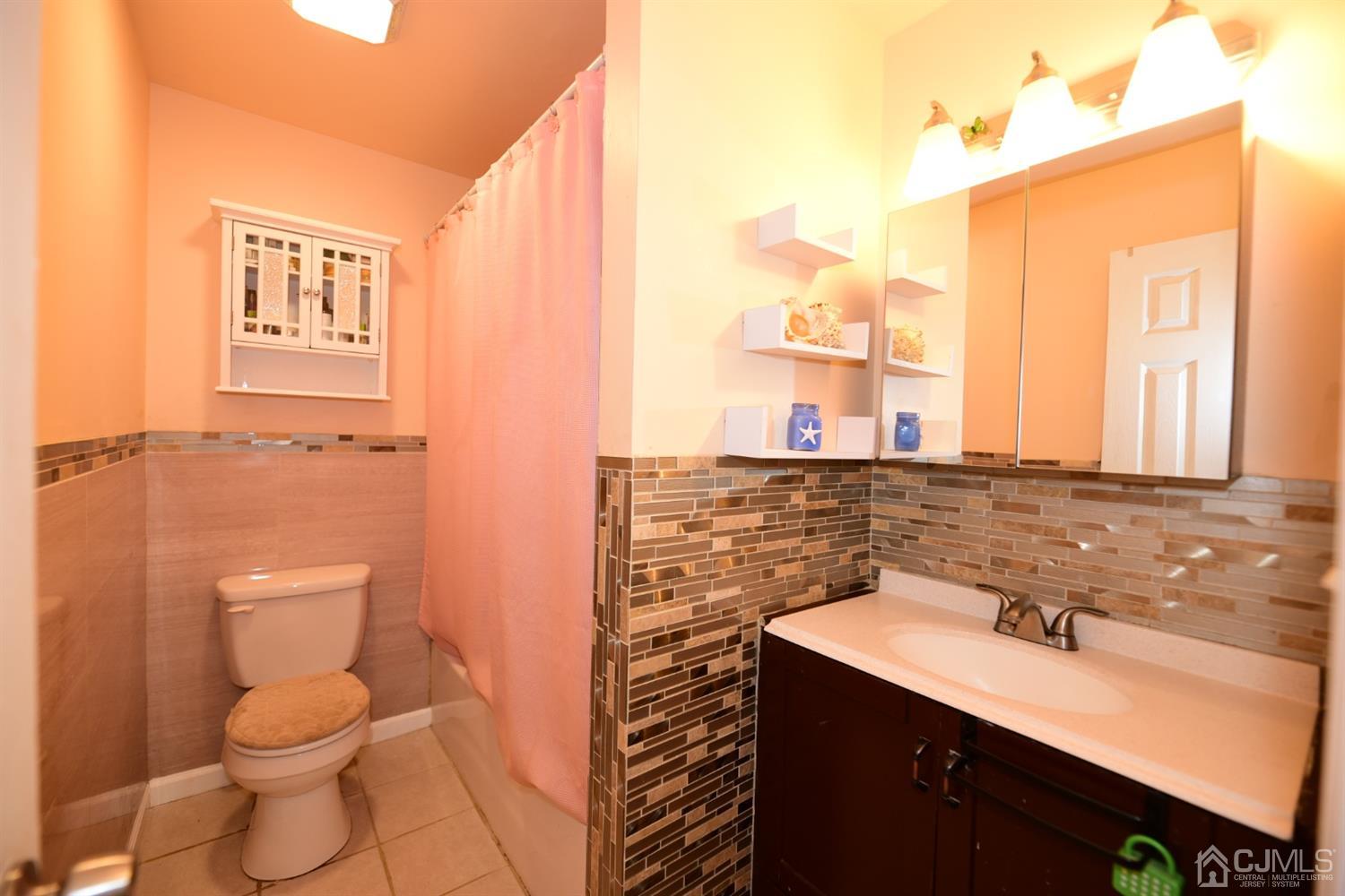 103 Tunison Road New Brunswick, NJ 08901 - Photo 10 of 30 a bathroom with a granite countertop sink toilet and shower