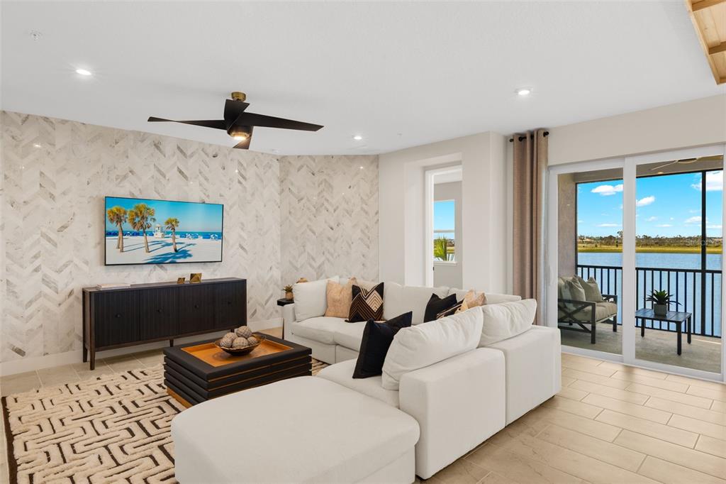 12785 Jade Empress Loop, Unit 202 Venice, FL 34293 - Photo 12 of 42 a living room with furniture and a ceiling fan