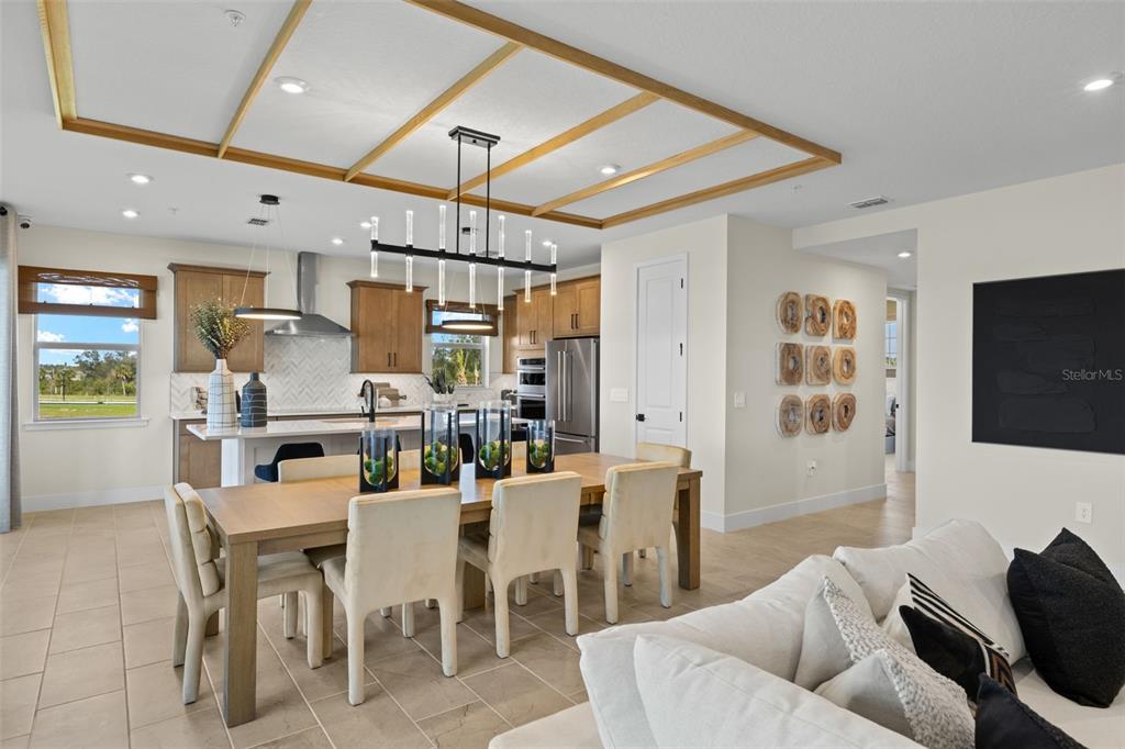 12785 Jade Empress Loop, Unit 202 Venice, FL 34293 - Photo 14 of 42 a living room with lots of furniture and a flat screen tv