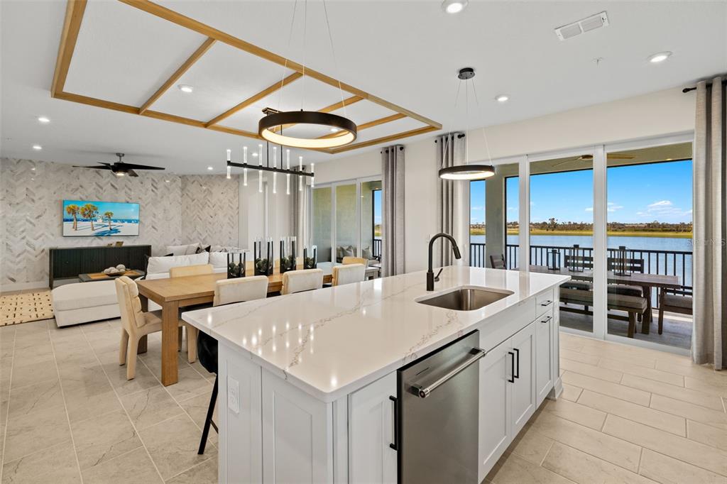 12785 Jade Empress Loop, Unit 202 Venice, FL 34293 - Photo 20 of 42 a kitchen with stainless steel appliances kitchen island granite countertop a sink and cabinets