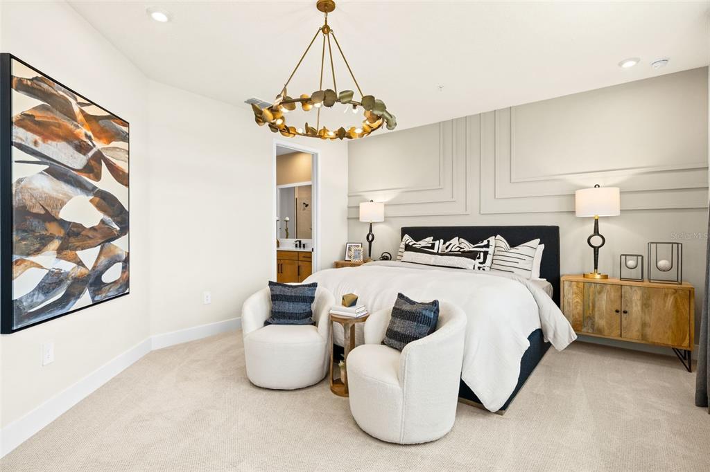 12785 Jade Empress Loop, Unit 202 Venice, FL 34293 - Photo 21 of 42 a bedroom with a bed and a chandelier