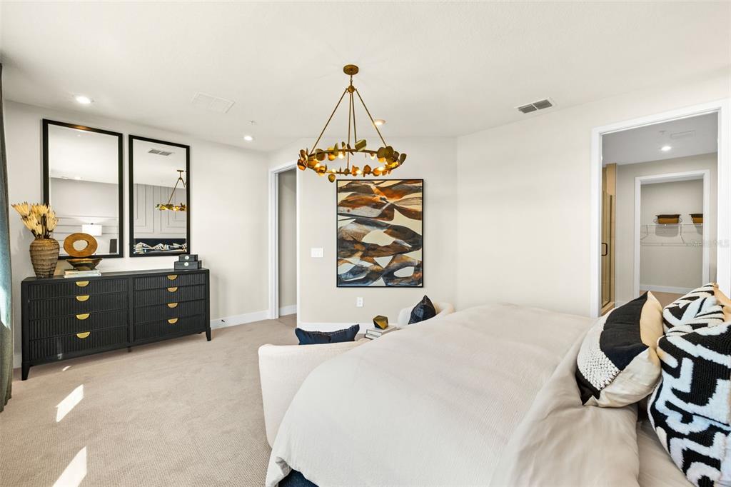 12785 Jade Empress Loop, Unit 202 Venice, FL 34293 - Photo 23 of 42 a bed room with a bed and a chandelier