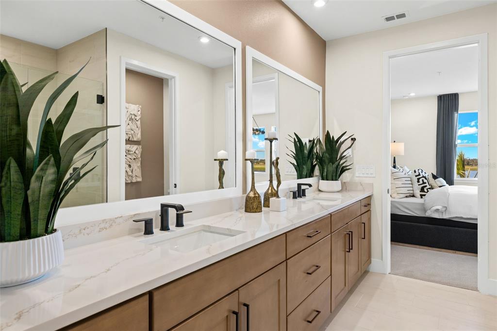 12785 Jade Empress Loop, Unit 202 Venice, FL 34293 - Photo 25 of 42 a bathroom with a double vanity sink and a mirror