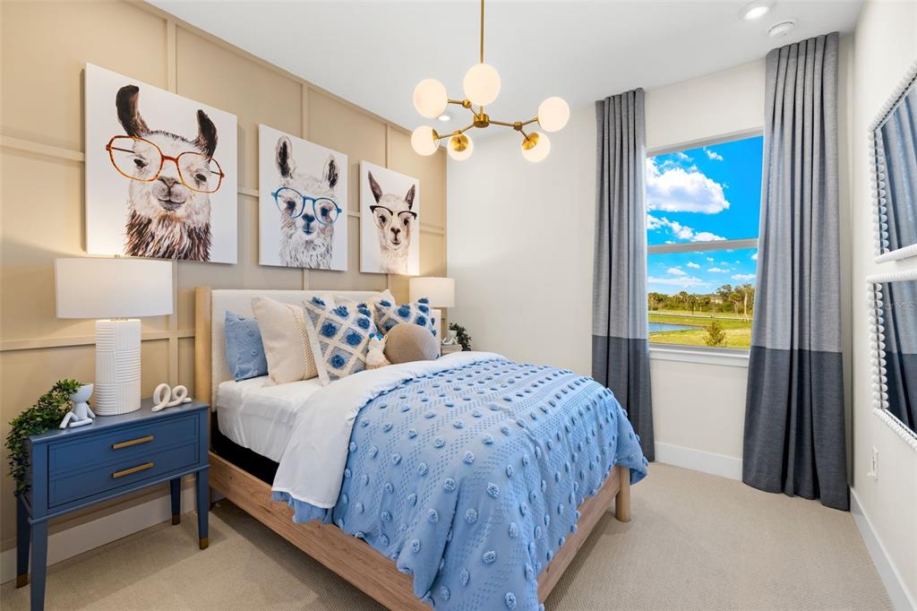 12785 Jade Empress Loop, Unit 202 Venice, FL 34293 - Photo 31 of 42 a bedroom with a bed and a window