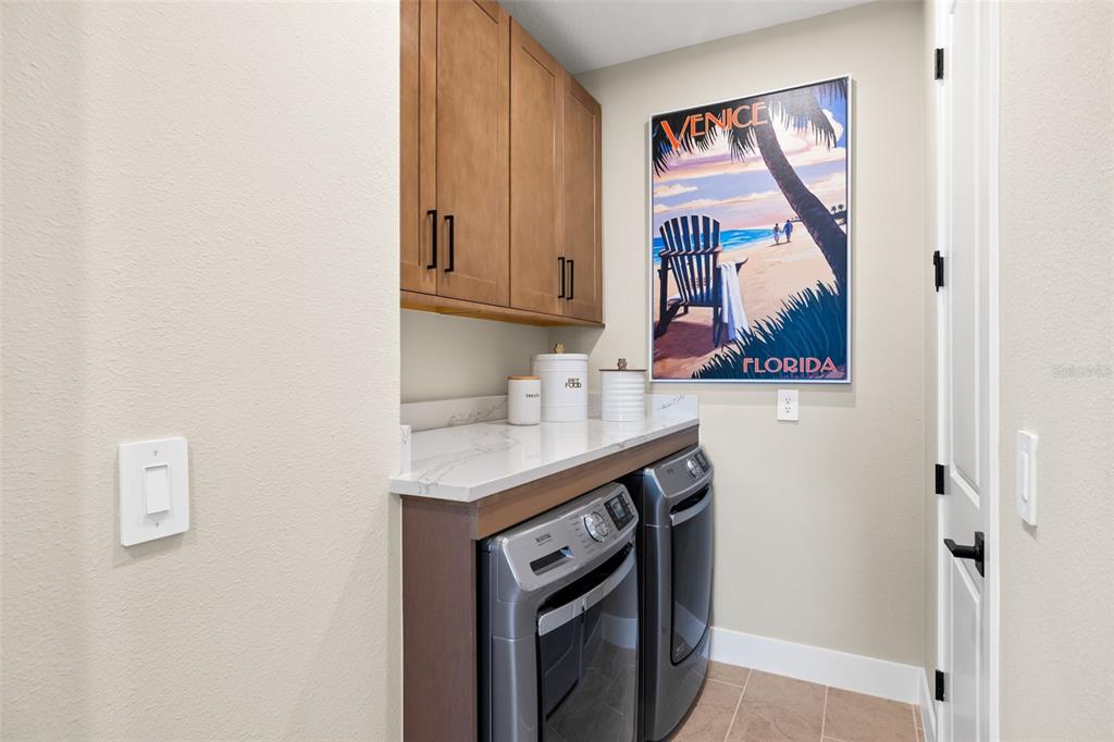 12785 Jade Empress Loop, Unit 202 Venice, FL 34293 - Photo 33 of 42 a view of a hallway with paintings on the wall