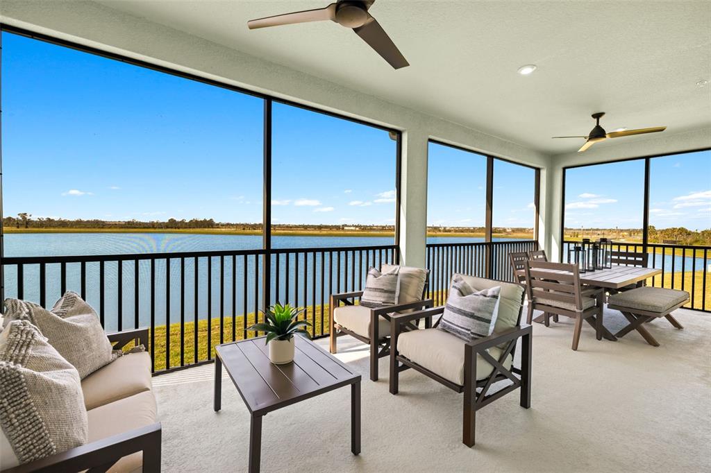 12785 Jade Empress Loop, Unit 202 Venice, FL 34293 - Photo 36 of 42 a living room with furniture and a floor to ceiling window