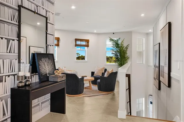 a living room with furniture and kitchen view