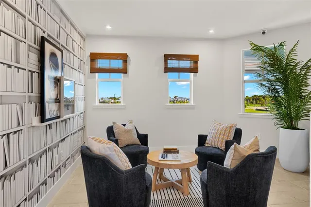 a living room with furniture a rug and a flat screen tv