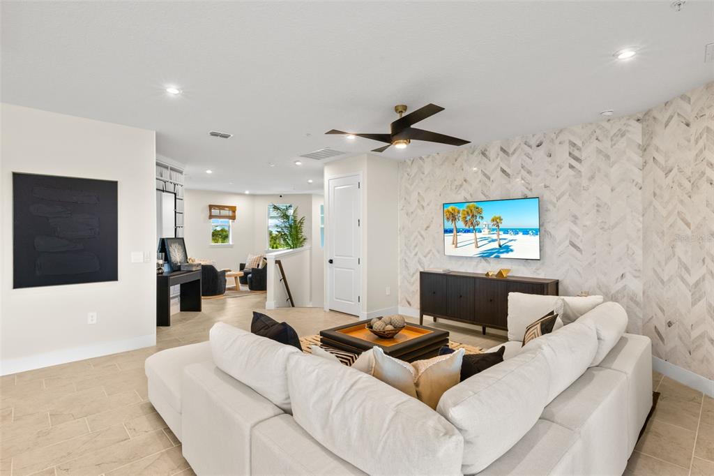 12785 Jade Empress Loop, Unit 202 Venice, FL 34293 - Photo 8 of 42 a living room with furniture and a flat screen tv