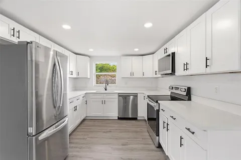 a kitchen with stainless steel appliances granite countertop a refrigerator sink and cabinets