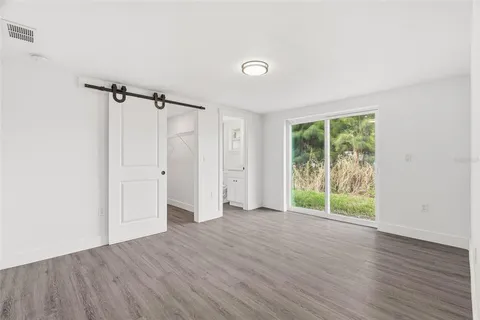 an empty room with wooden floor and a window