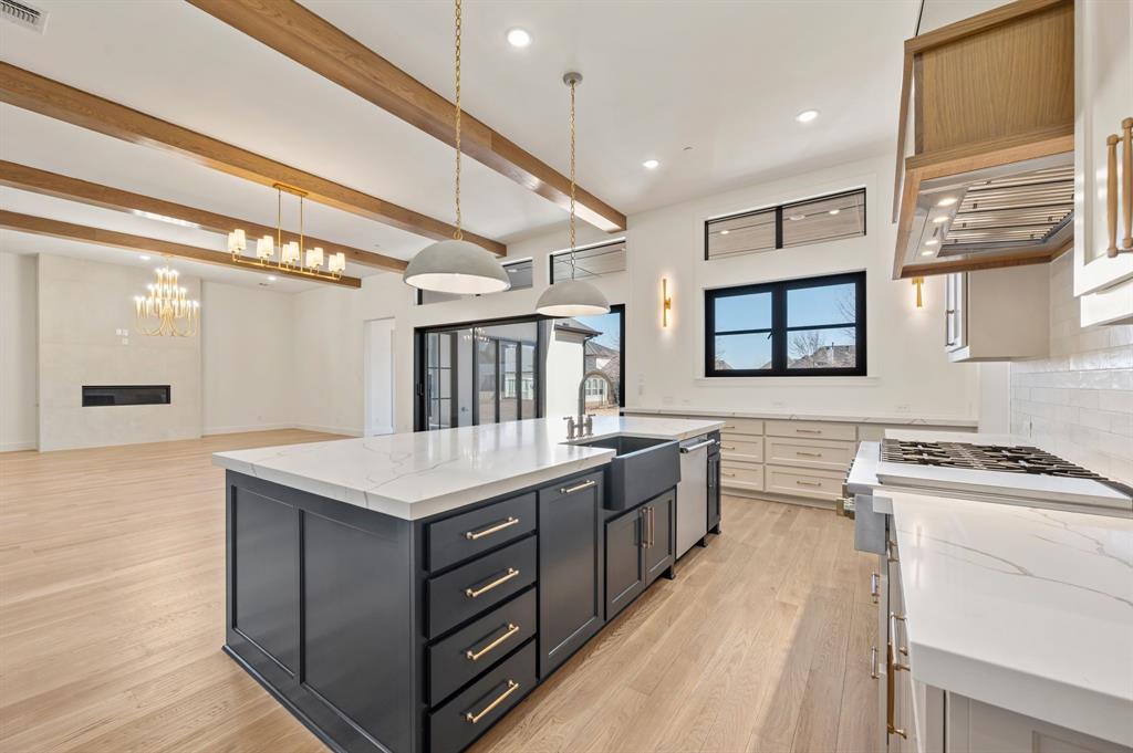 1460 Copper Point Drive Prosper, TX 75078 - Photo 15 of 40 a kitchen with stainless steel appliances granite countertop a stove and a sink