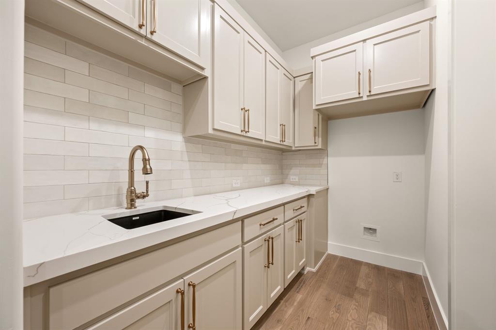 1460 Copper Point Drive Prosper, TX 75078 - Photo 18 of 40 a kitchen with cabinets and a stove