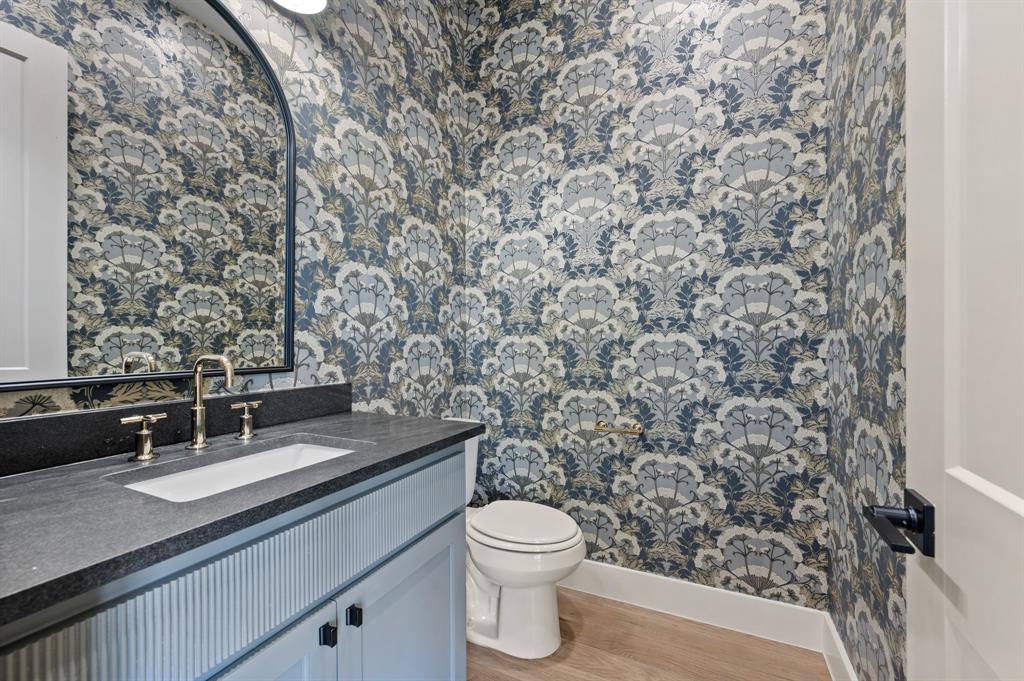 1460 Copper Point Drive Prosper, TX 75078 - Photo 25 of 40 a bathroom with a granite countertop sink and a toilet
