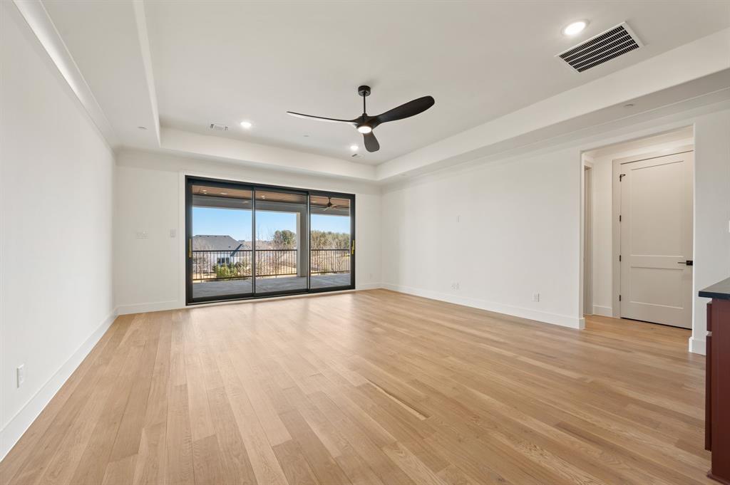 1460 Copper Point Drive Prosper, TX 75078 - Photo 28 of 40 an empty room with wooden floor and windows