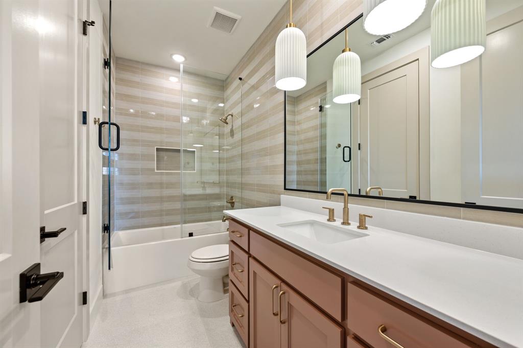 1460 Copper Point Drive Prosper, TX 75078 - Photo 30 of 40 a bathroom with a sink a toilet and shower