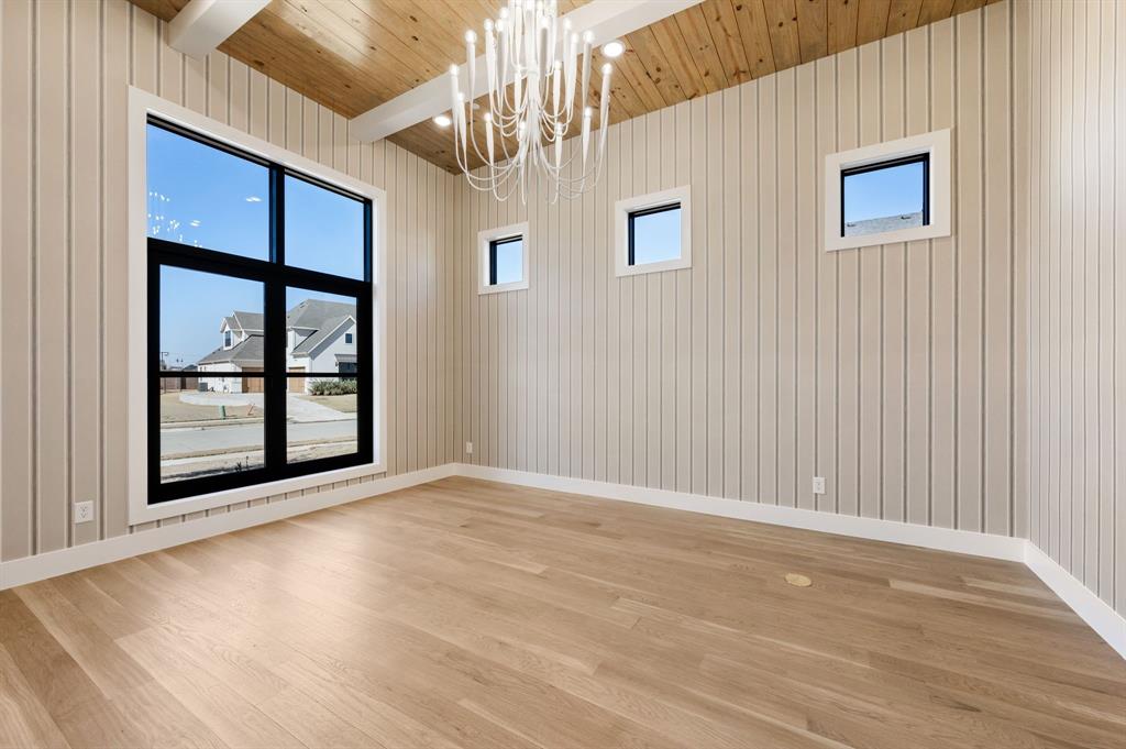 1460 Copper Point Drive Prosper, TX 75078 - Photo 6 of 40 a view of an empty room with a window and wooden floor
