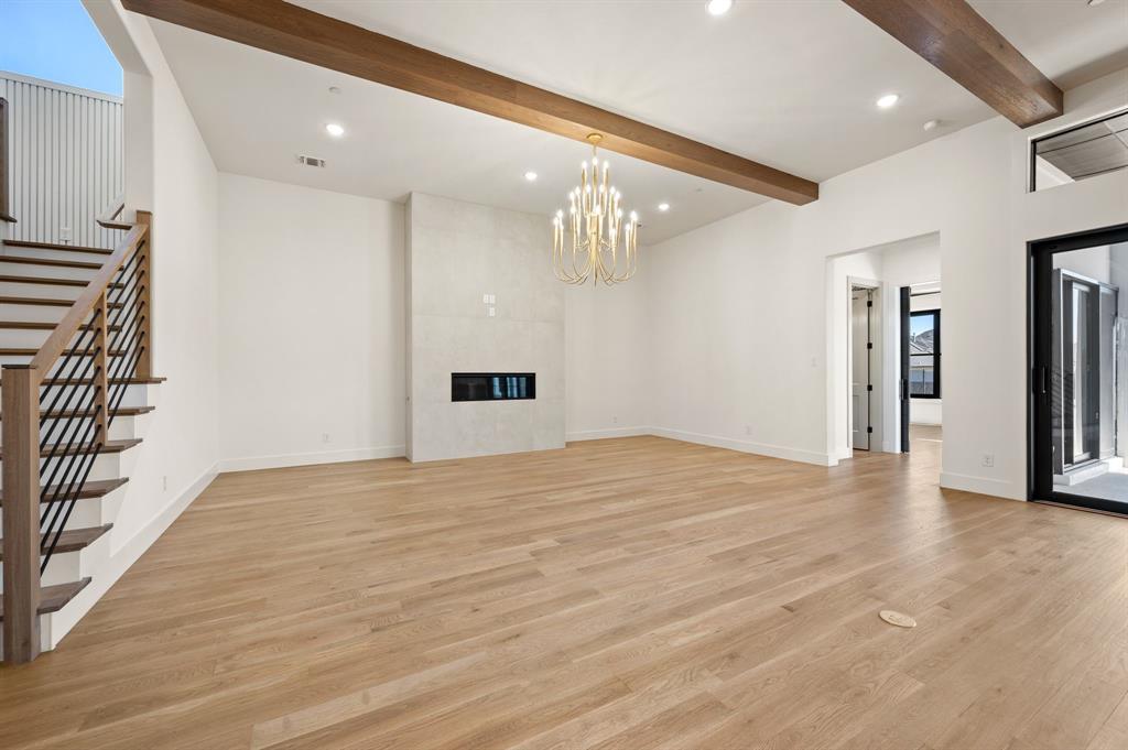 1460 Copper Point Drive Prosper, TX 75078 - Photo 7 of 40 a view of an empty room with wooden floor and staircase
