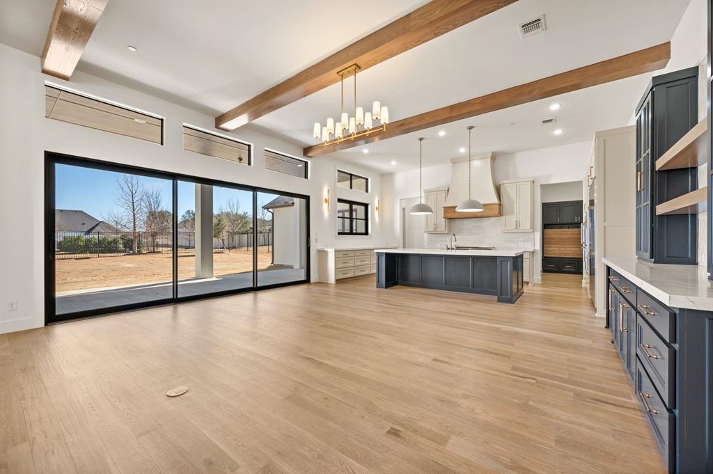 1460 Copper Point Drive Prosper, TX 75078 - Photo 9 of 40 a view of an empty room with kitchen and window