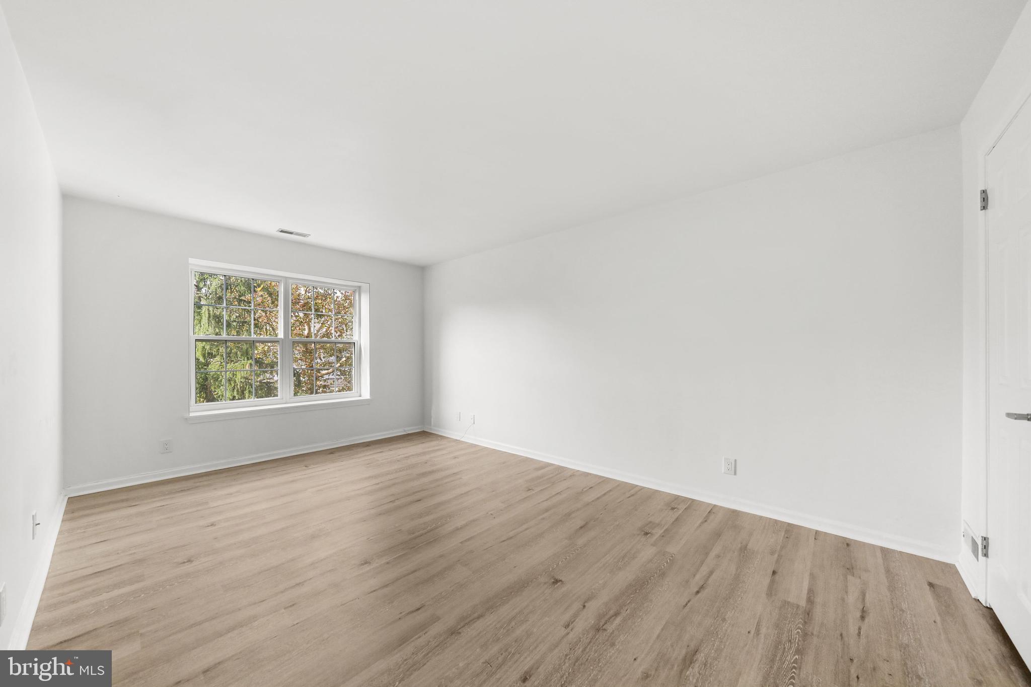 4204 Fenwick Lane Mount Laurel, NJ 08054 - Photo 12 of 27 an empty room with wooden floor and windows