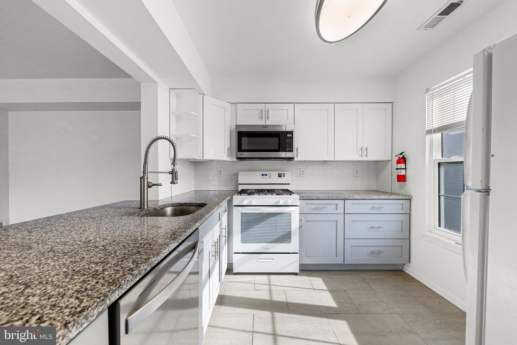 4204 Fenwick Lane Mount Laurel, NJ 08054 - Photo 6 of 27 a kitchen with granite countertop a sink stove and cabinets