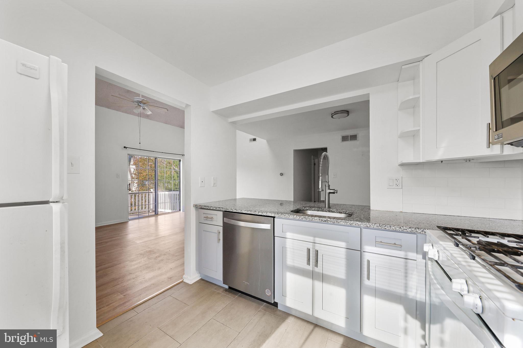 4204 Fenwick Lane Mount Laurel, NJ 08054 - Photo 7 of 27 a kitchen with stainless steel appliances granite countertop a stove and a sink